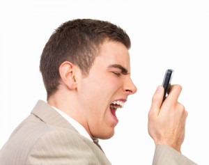 Angry business man screaming at his  cell phone